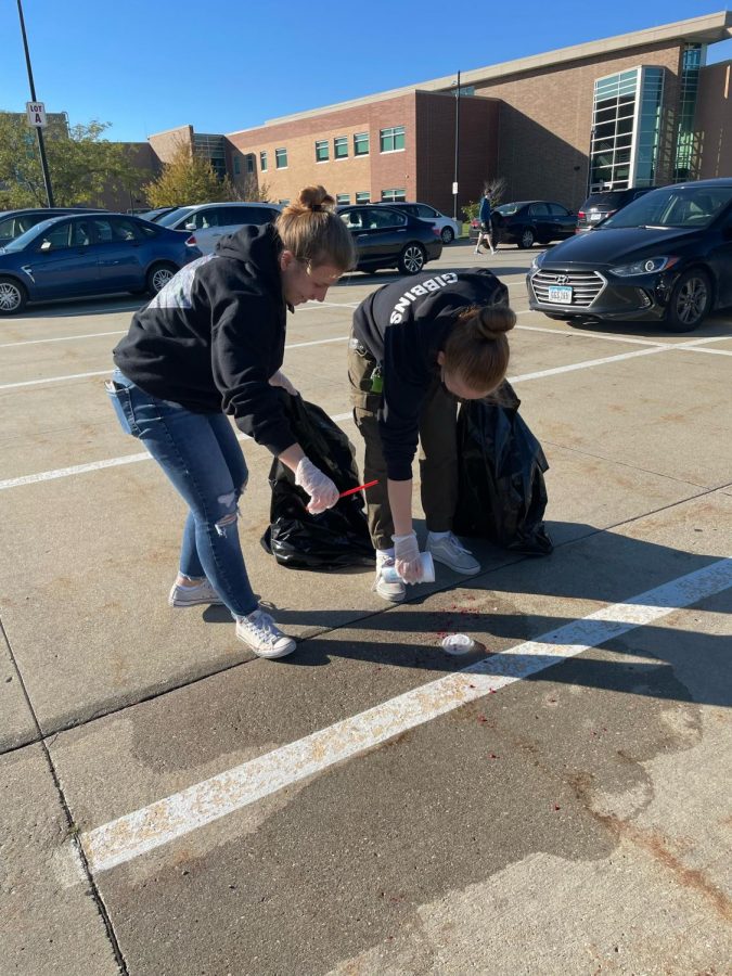 Seniors Morgan Gholson and Grace Gibbons pick up trash at the Student Political Engagement Club (SPEC) parking lot pickup event on Oct. 14, 2021. 