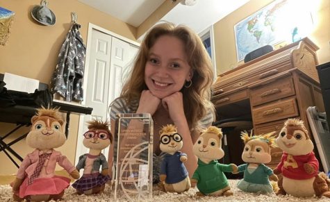 AHS junior Chloe McGrath poses with the stuffed animal chipmunk collection she used to create the video that won her an Upper Midwest Student Production Award from the National Academy of Television and Arts, “Chipmunks Lost in Time.”
