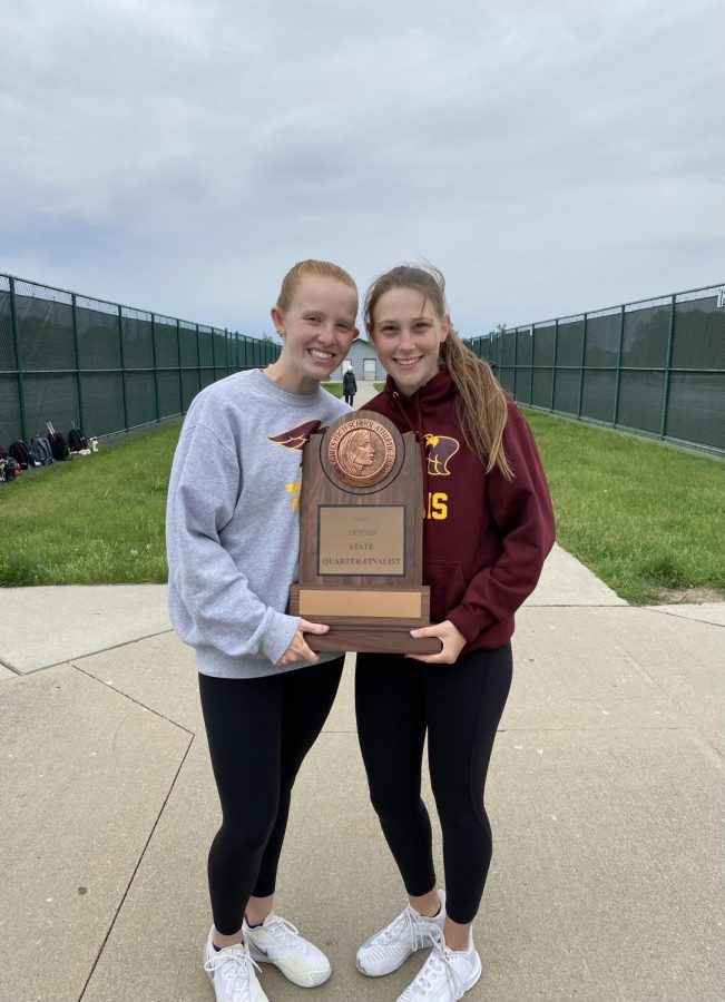 Schmitz (left) and Johnson (right) pose for a photo with Ankeny’s new trophy for tennis team-state quarter finalists. Schmitz and Johnson both played singles against Dowling Catholic during the team state tournament last Saturday, May 21.