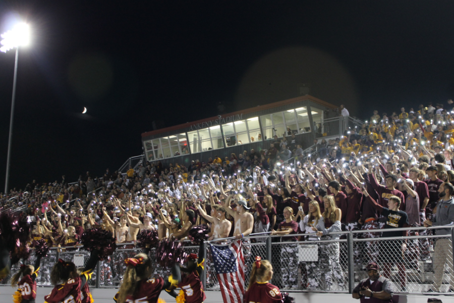 The+AHS+student+section+hold+up+flashlights+during+the+Homecoming+game+against+Valley+High+School+at+Ankeny%E2%80%99s+stadium+on+Sept.+30%2C+2022.