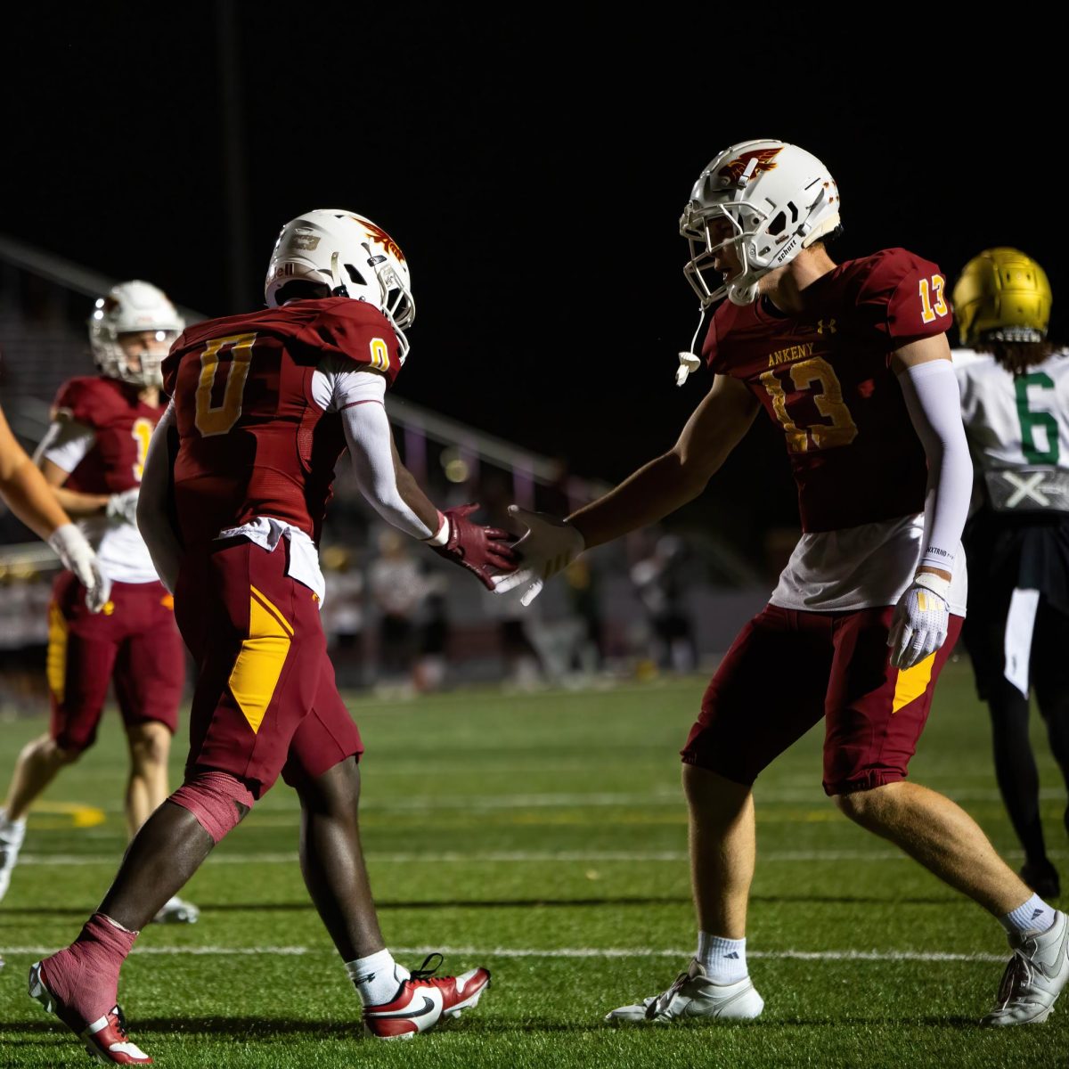 Junior Daniel Larmie (0) celebrates a touchdown with junior Andrew Brandhorst (13) in the endzone.
