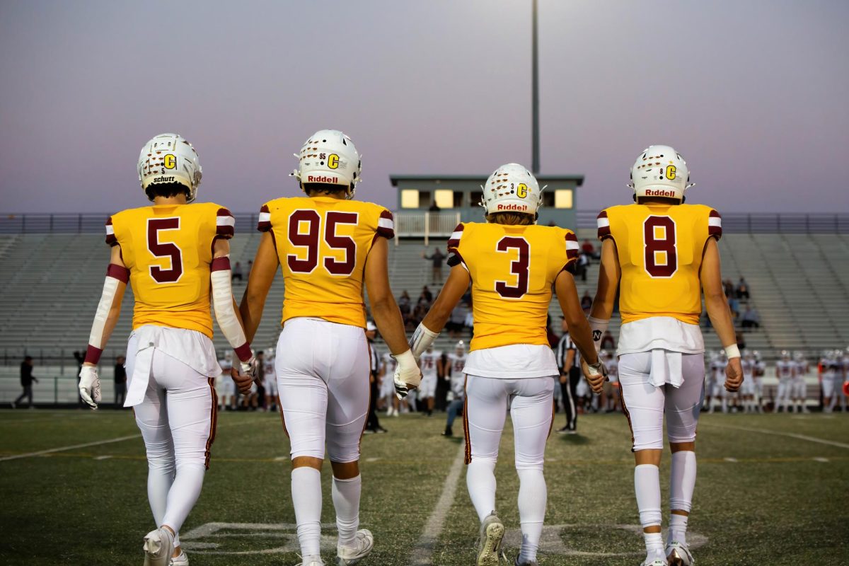 Senior captains Caden Henkes (5), Andrew Haase (95), Kinnick Vos (3), and Luke Anderson (8) take the field for the coin toss.
