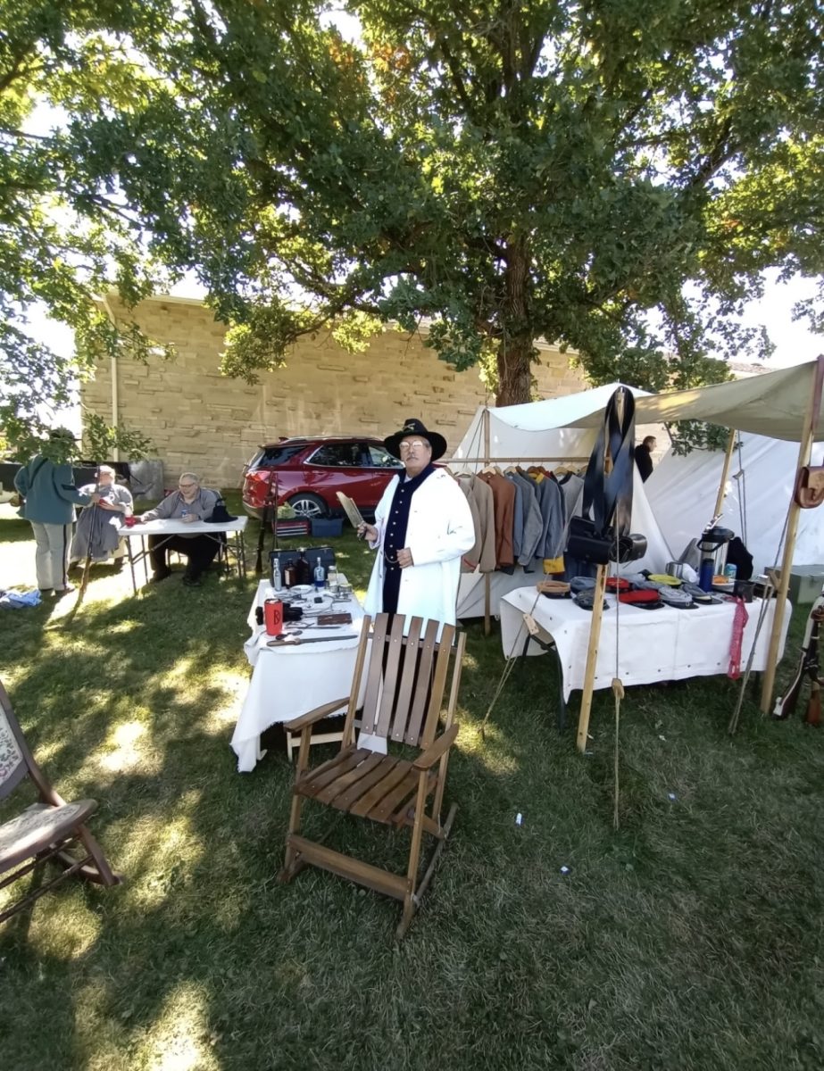 Kevin Daniels poses at a Civil War reenactment event.  Daniels embodies an intense passion for history, showing its artifacts and sharing its stories to anyone willing to listen. His legacy as a history connoisseur inspires future generations. 
