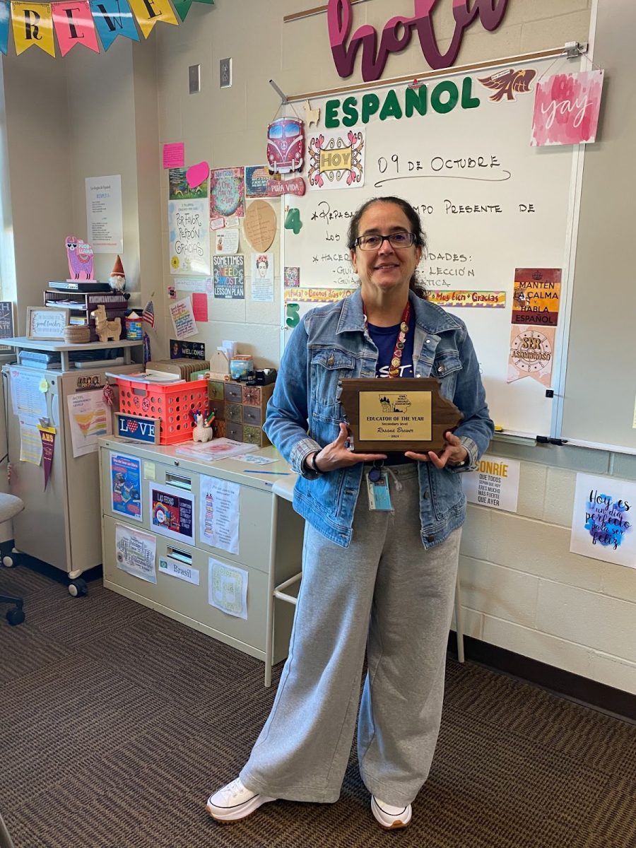 Spanish teacher Rosana Brewer holding her plaque awarded for winning Educator of the Year (Secondary Level) by the Iowa World Language Association