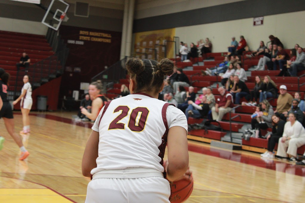 Senior Jade Moser (20) inbounds the basketball. “It [playing on varsity] feels really great to just be here with my team," Moser said. "We've had a lot of posts in the past...It just feels great to be able to feel that role and be here for the team the same way they contributed in the past.”