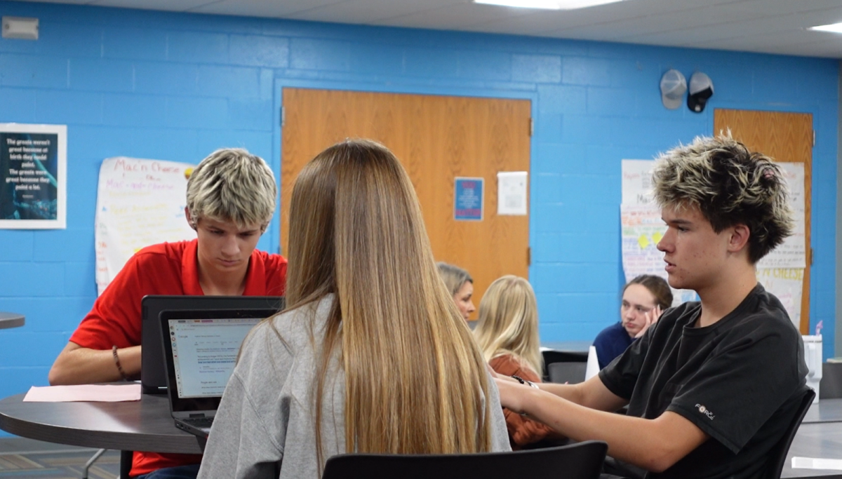 Teacher Academy students from Ankeny Centennial, juniors Parker Wilson, Tony Mandolfo, and Sophia Royster develop their lesson plans that will be presented to the class. “[Teacher Academy students are] getting the experience of actually seeing if this is a career. They're getting that time in the classroom,” Teacher Academy and science teacher Kristen Campbell-Blumhagen (CB) said.