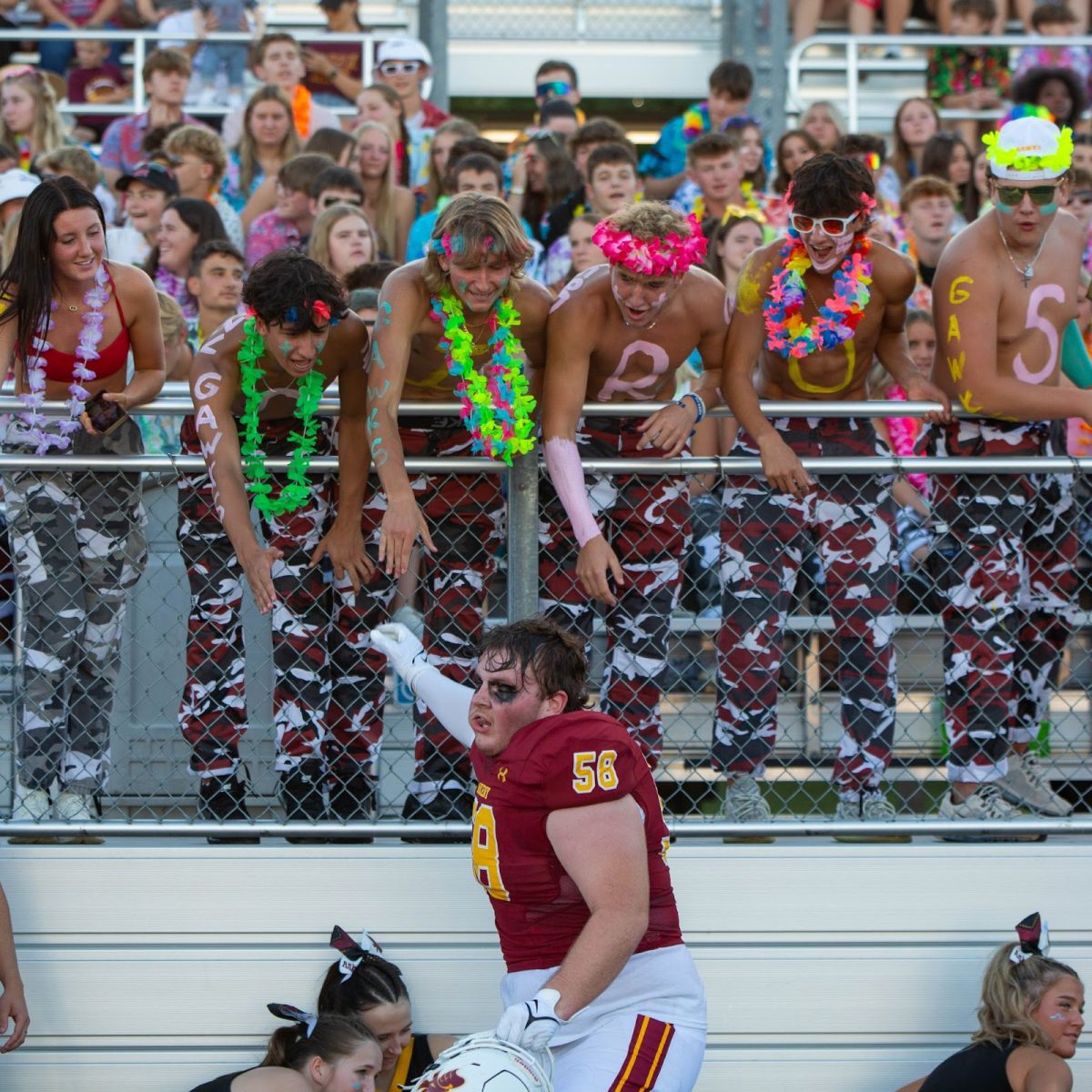 Senior Landen Rutter goes to high-five the student section before the football season's first game against cross-town rival Centennial.  