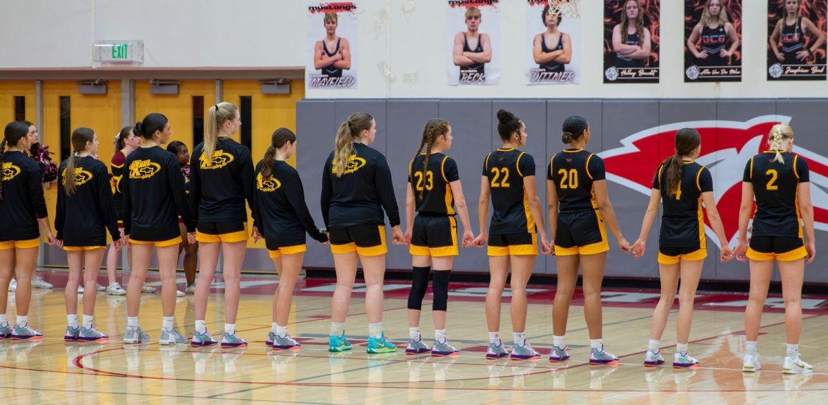 Ankeny Girls Basketball stand for the National Anthem before a game against Dallas Center Grimes on January 1. Photo by Grady Andersen