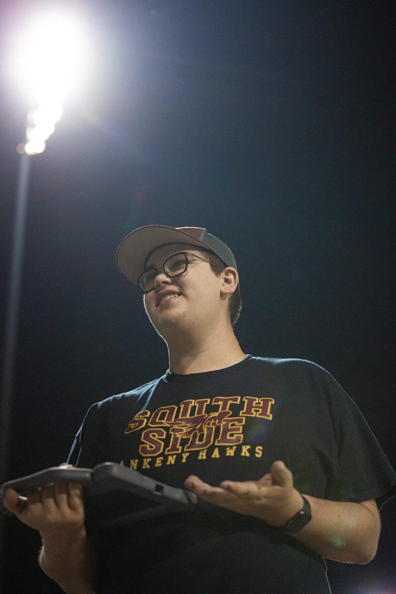 Senior Grady Andersen keeps stats at an Ankeny Hawks baseball game. He’s been helping with the team since his freshman year, and added roles in basketball and football by sophomore year. “Grady has found a place,” said his dad, Kiron Andersen. “And I hope he's created an opportunity for someone else.” That sense of opportunity and support runs through everything Grady does—from filming plays to mentoring underclassmen. Photo published with permission from Dylan Shoemaker (@thefittestphotographer)