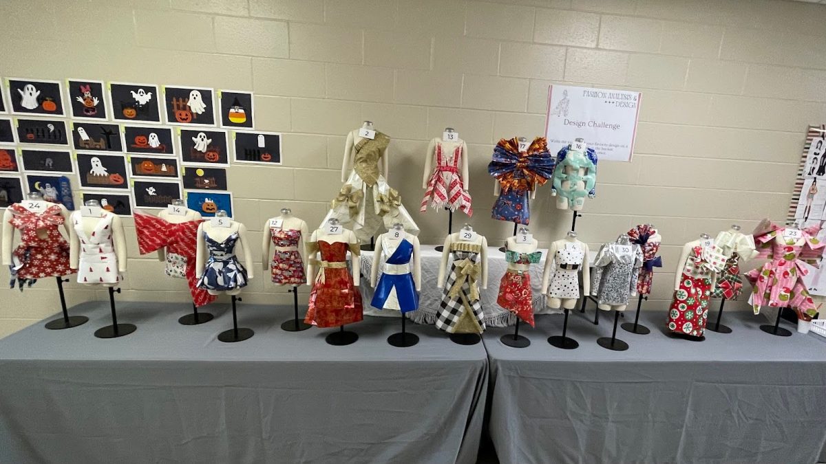 The finished dresses from the wrapping paper themed unconventional fashion competition are on display in the 1500’s hallway. The hard work and creativity of students stand proudly awaiting voters.