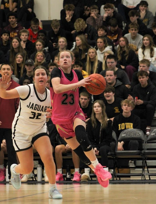 Ankeny senior Ainsley Kiene (23) drives past a Centennial defender. Kiene had 14 points in the victory for the Hawkettes.