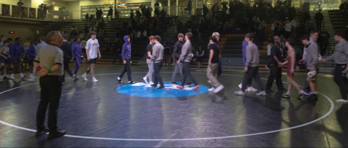 Coaches and players shake hands post-dual with Ankeny defeating Johnston 41-30 on December 18th. 