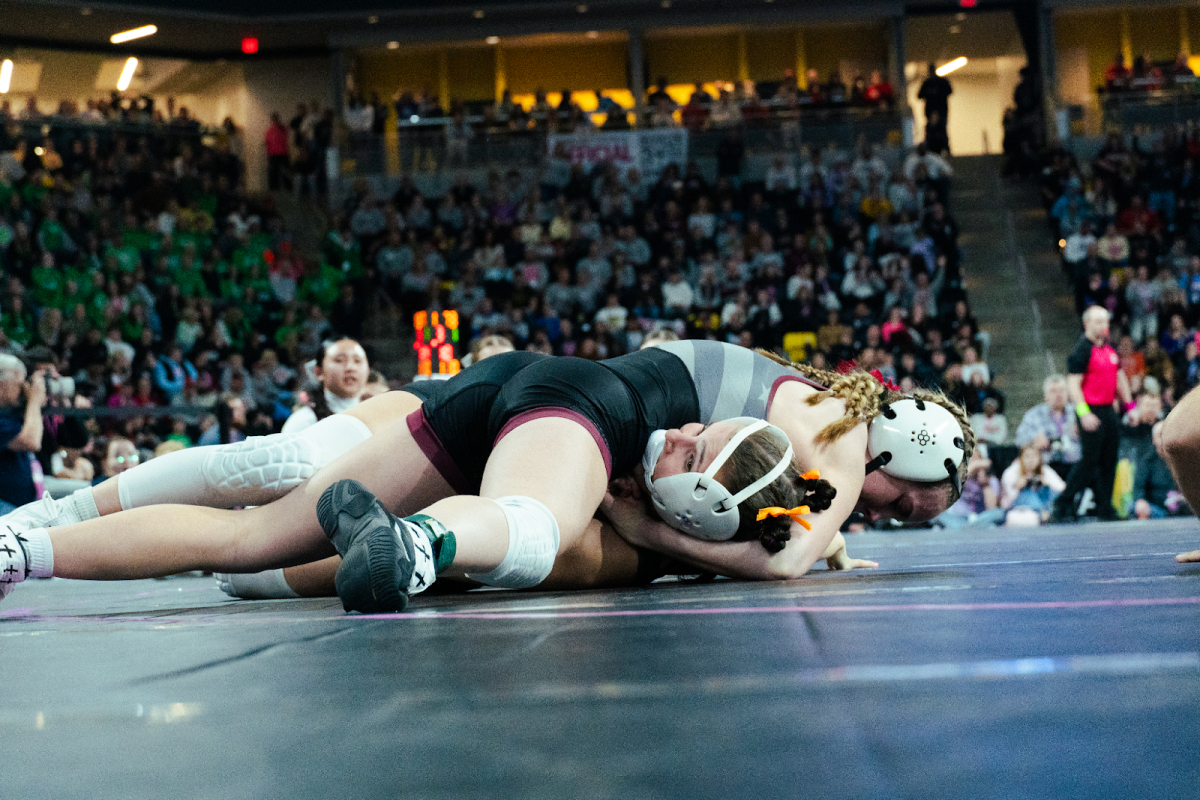 Ankeny wrestler from Bondurant-Farrar, Lauren Watson, settles in a pin after chin-whipping three-time state champ Katie Biscoglia from Raccoon River, resulting in what is being considered the biggest upset in girls wrestling history. Despite all the labels and accomplishments Biscoglia has, Watson was able to walk into the match fearless, a word Watson used to describe e 25-26 AGW season.