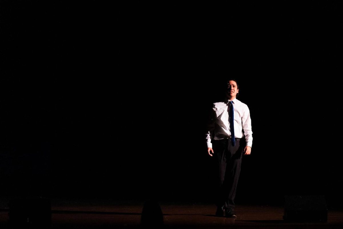 Senior Jack Ponto (Frank Abagnale Jr.) stands in the abyss as the spotlight beams down on him. 
