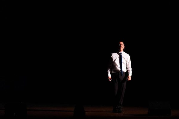 Senior Jack Ponto (Frank Abagnale Jr.) stands in the abyss as the spotlight beams down on him. 